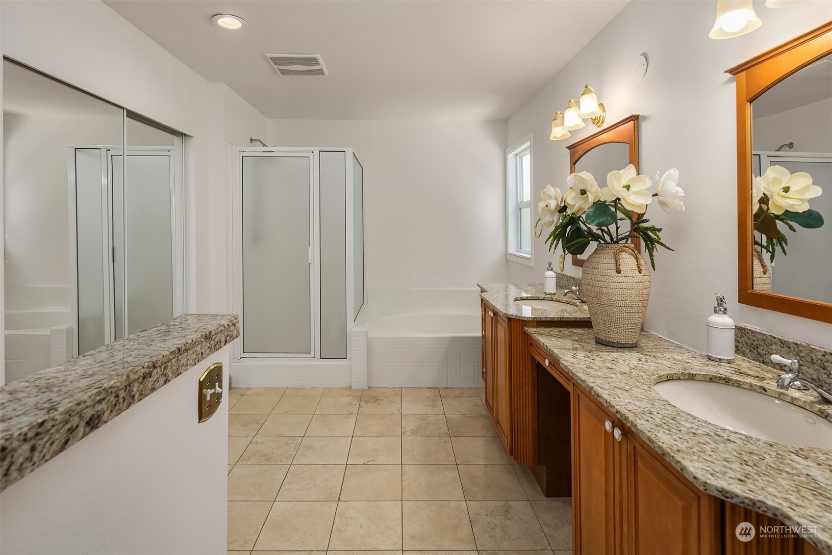 9222 Northeast 173rd Place Bothell, WA 98011 - Photo 18 of 37 a spacious bathroom with a granite countertop double vanity sink a mirror and a bathtub