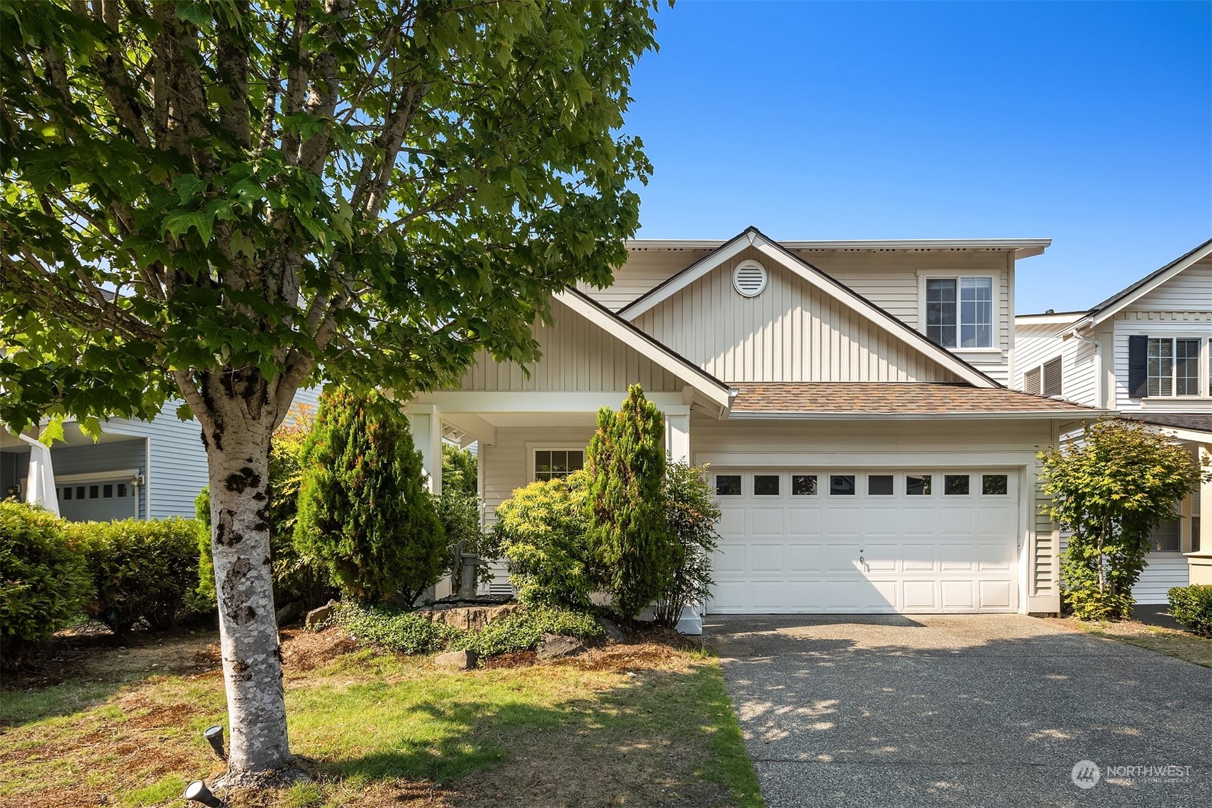 9222 Northeast 173rd Place Bothell, WA 98011 - Photo 2 of 37 a front view of a house with a yard garage and outdoor seating