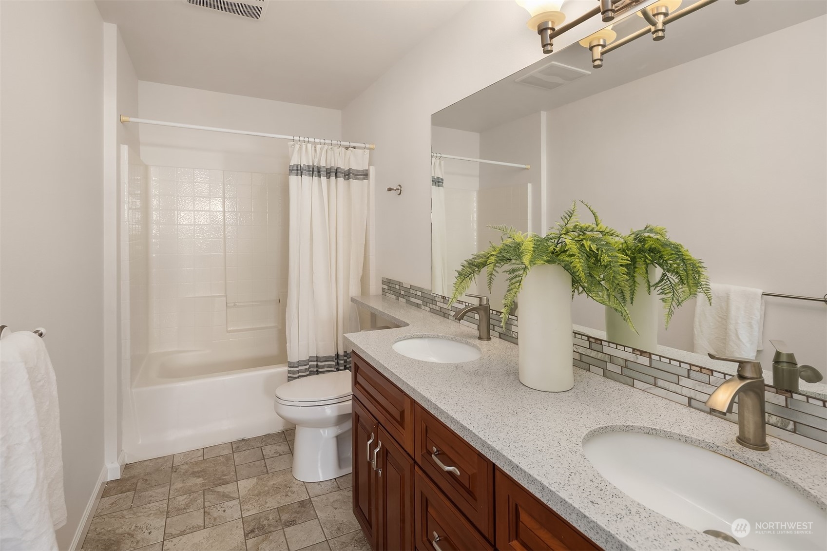 9222 Northeast 173rd Place Bothell, WA 98011 - Photo 25 of 37 a bathroom with a granite countertop sink a toilet and shower