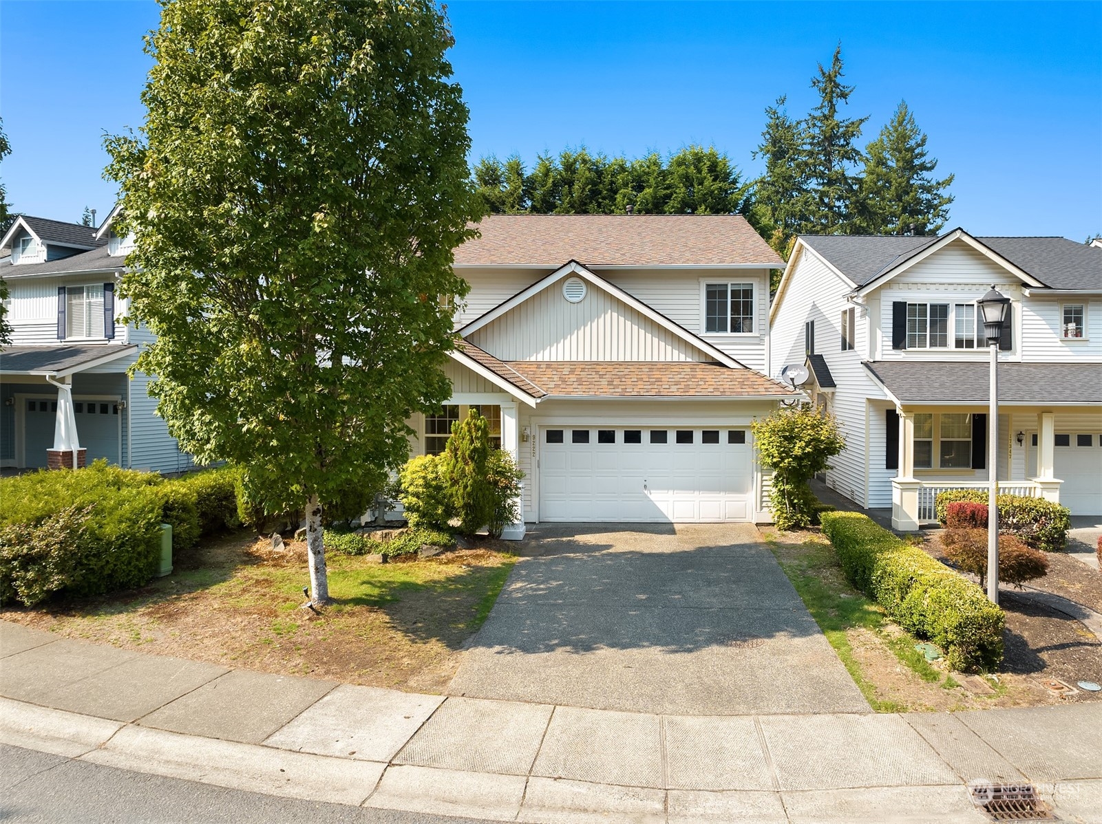 9222 Northeast 173rd Place Bothell, WA 98011 - Photo 33 of 37 a front view of a house with a yard and potted plants