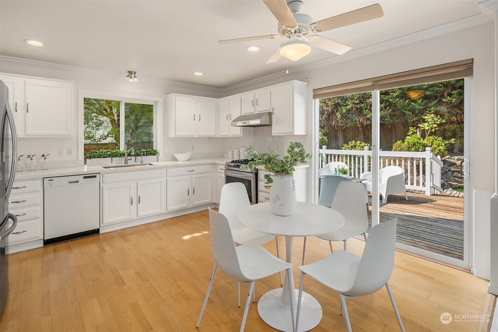 9222 Northeast 173rd Place Bothell, WA 98011 - Photo 6 of 37 a kitchen with stainless steel appliances granite countertop a stove a kitchen island a table and chairs