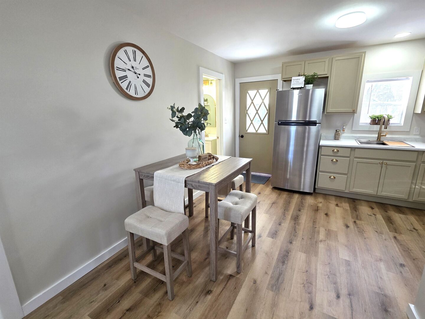 312 Lincoln Avenue Flora, IL 62839 - Photo 25 of 80 a kitchen with stainless steel appliances a refrigerator a stove a dining table and chairs