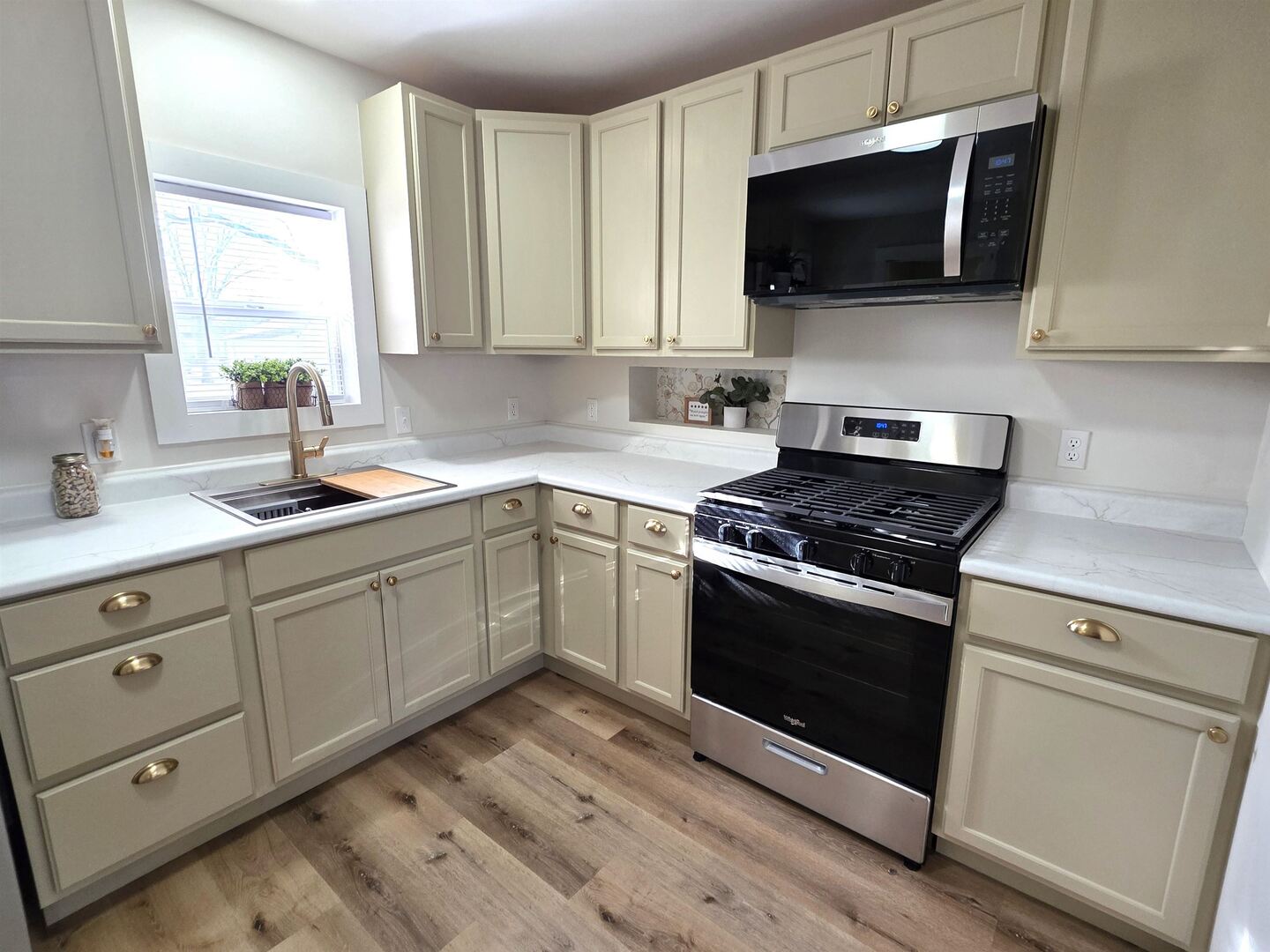 312 Lincoln Avenue Flora, IL 62839 - Photo 26 of 80 a kitchen with cabinets stainless steel appliances and wooden floor