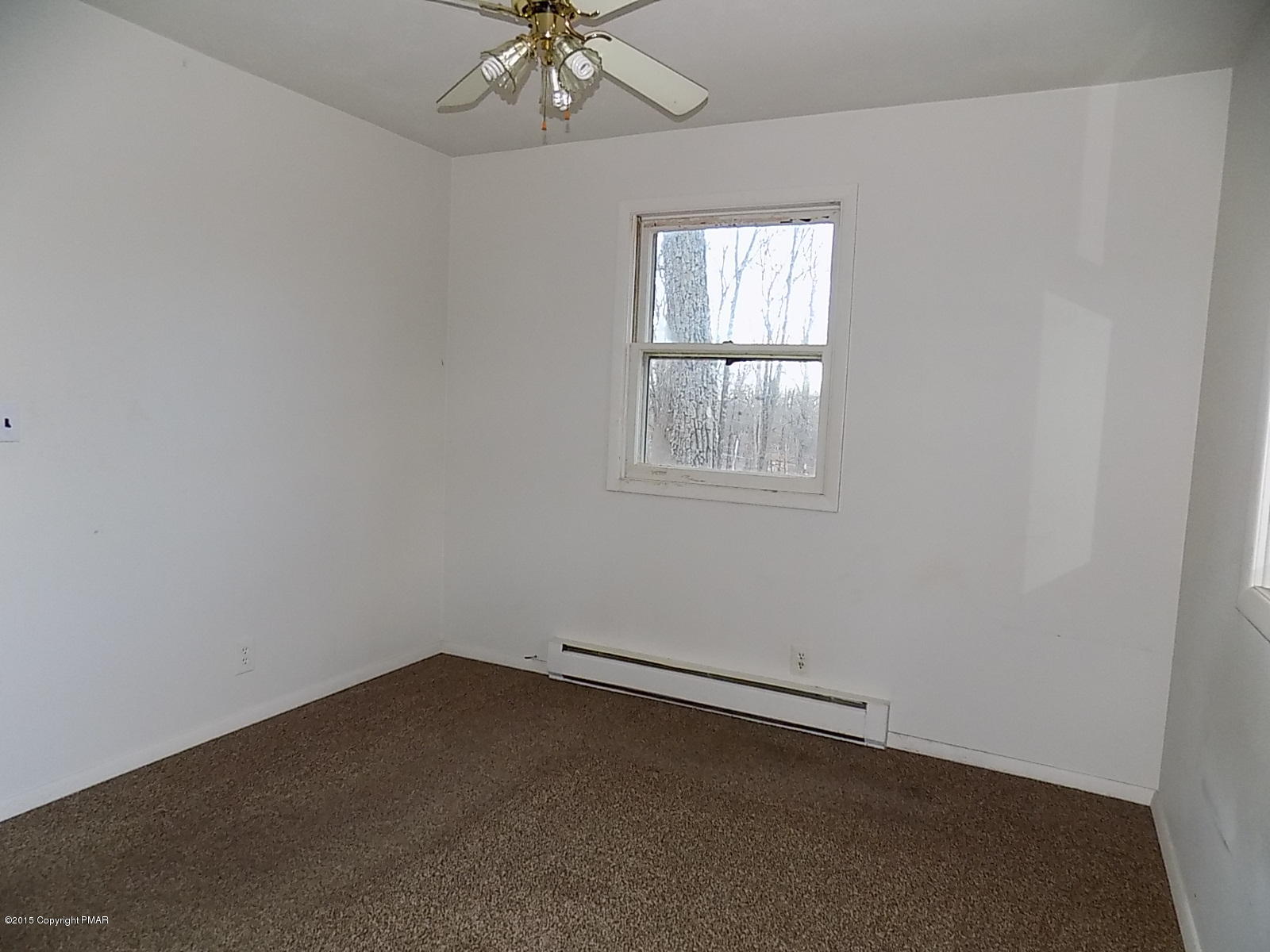 856 Gold Finch Road Bushkill, PA 18324 - Photo 4 of 10 an empty room with a window