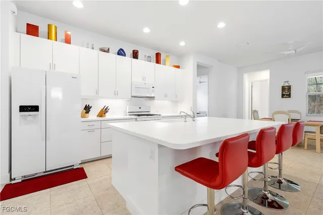 a kitchen with stainless steel appliances kitchen island granite countertop a sink and cabinets