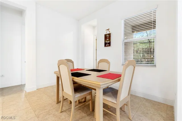 a dining room with furniture and window