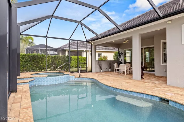 a swimming pool with outdoor seating