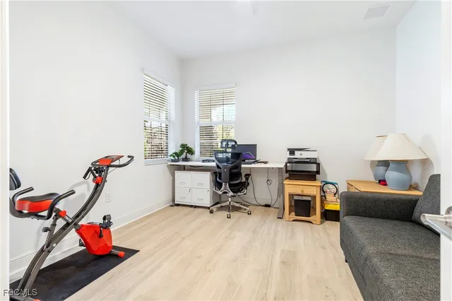 a workspace with furniture and a wooden floor