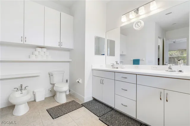 a bathroom with a sink mirror and toilet