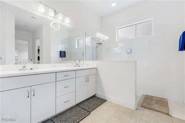a spacious bathroom with a double vanity sink mirror and