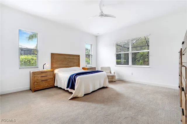 a spacious bedroom with a bed and wooden floor