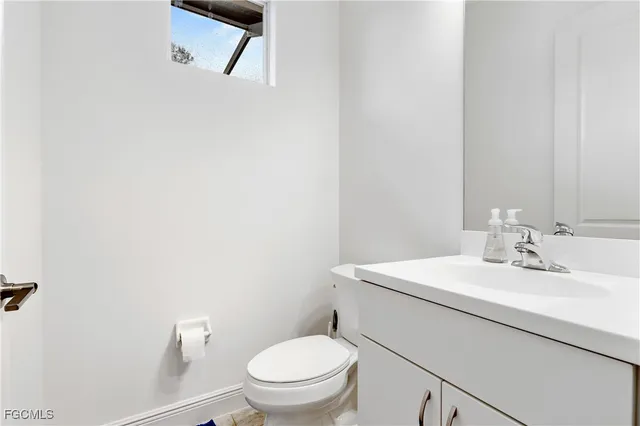 a bathroom with a toilet a sink and mirror