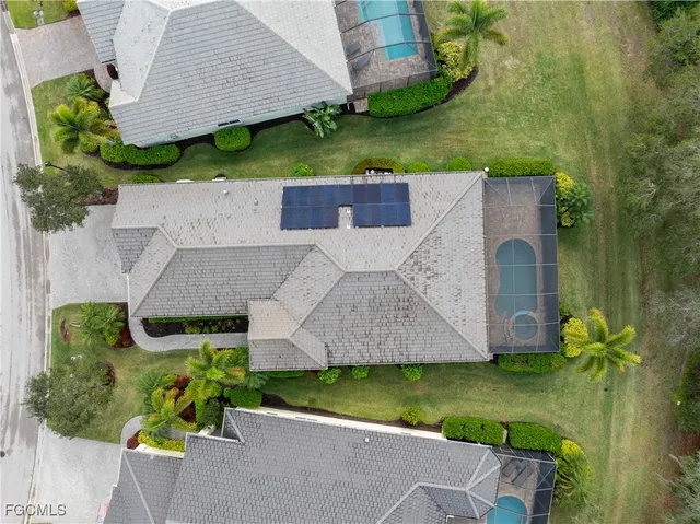an aerial view of a house with a yard
