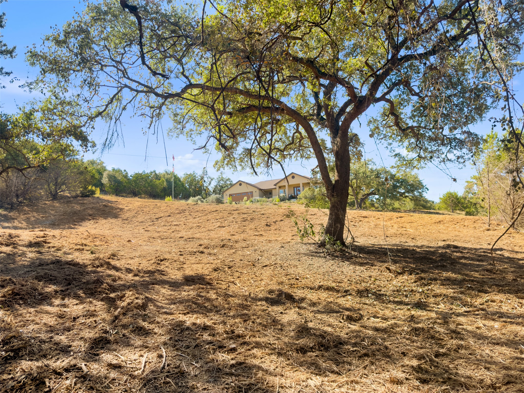 817 Rutherford Fischer, TX 78623 - Photo 11 of 22 A spacious lot provides ample room for expansion, offering views of the distant, inviting residence.