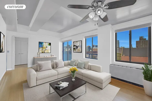 a living room with furniture a ceiling fan and a window