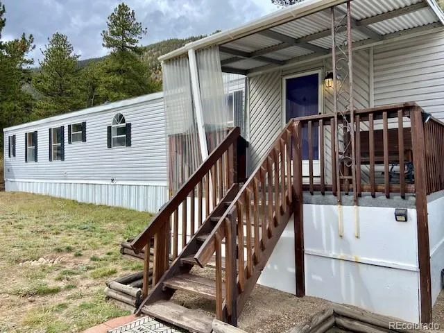 a view of a house with backyard and deck