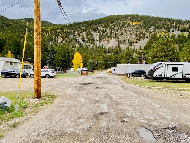 54 Windy Gap Loop Empire, CO 80438 - Photo 40 of 48 a view of a swimming pool with a lawn chairs under an umbrella