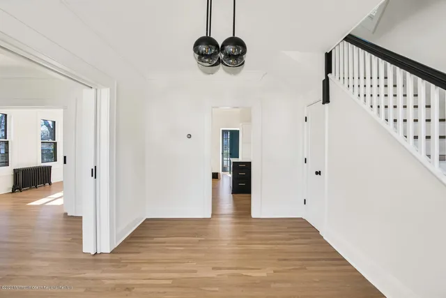 a view of entryway and hall with wooden floor