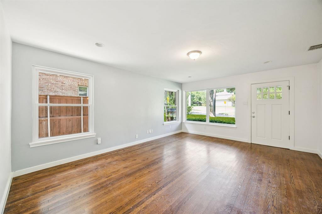 6742 Williamson Road Dallas, TX 75214 - Photo 4 of 11 Expansive LIVING ROOM Situated at Front of Home Features Multiple Oversized Windows, Recessed Lighting, Neutral Colors, and Wood Floors