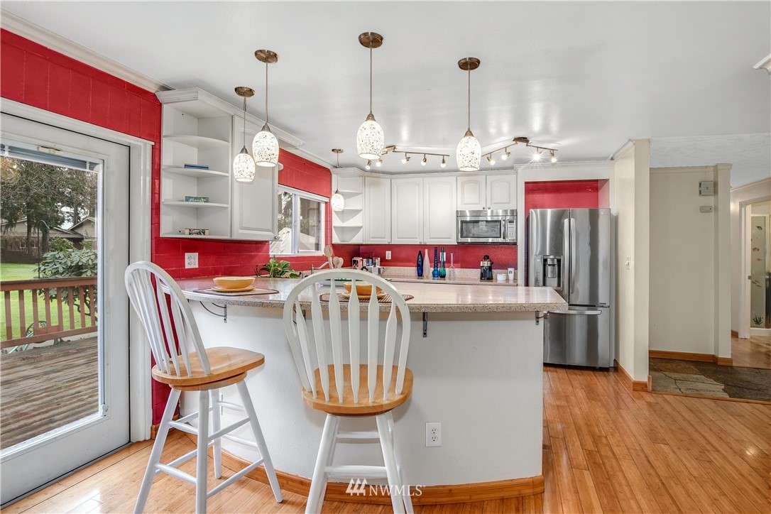 17618 Southeast 293rd Place Kent, WA 98042 - Photo 6 of 35 a kitchen with stainless steel appliances granite countertop a kitchen island a stove a table and chairs