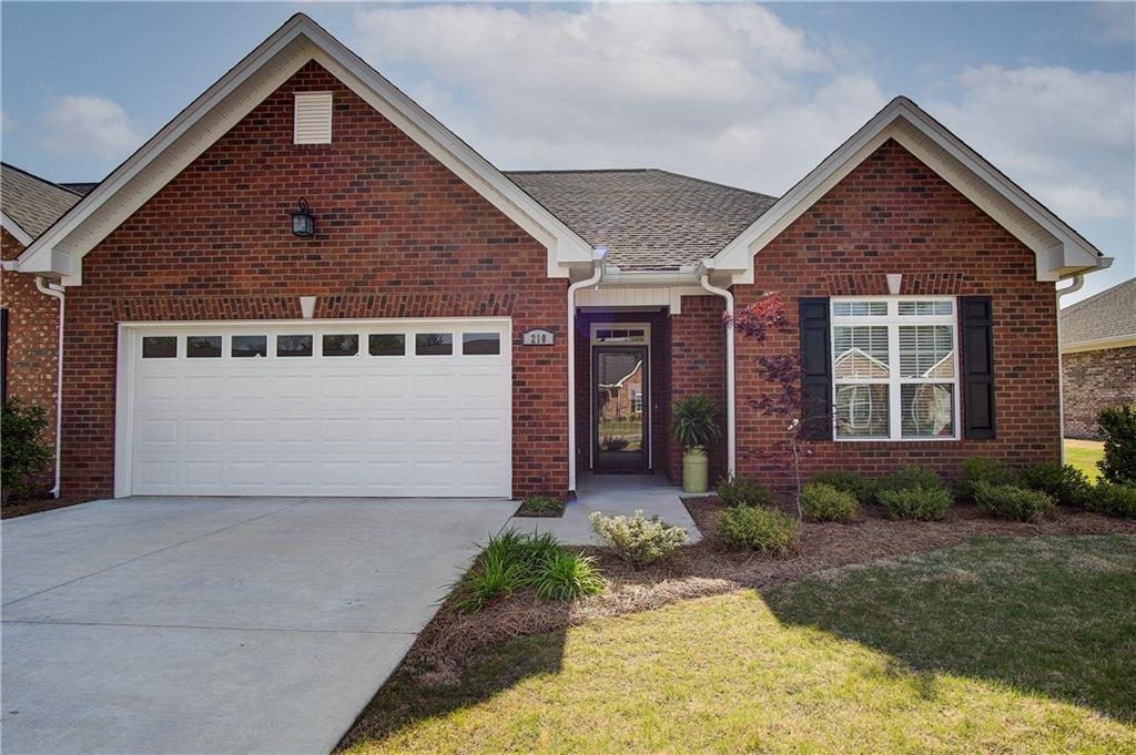 210 Patriots Row Southwest Calhoun, GA 30701 - Photo 1 of 1 a front view of a house with garden