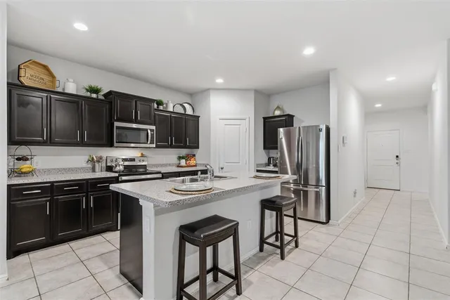 a living room with furniture and kitchen view