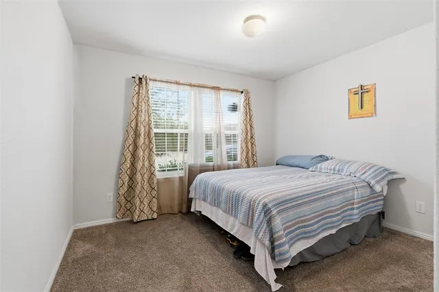 a bed sitting in a bedroom next to a window