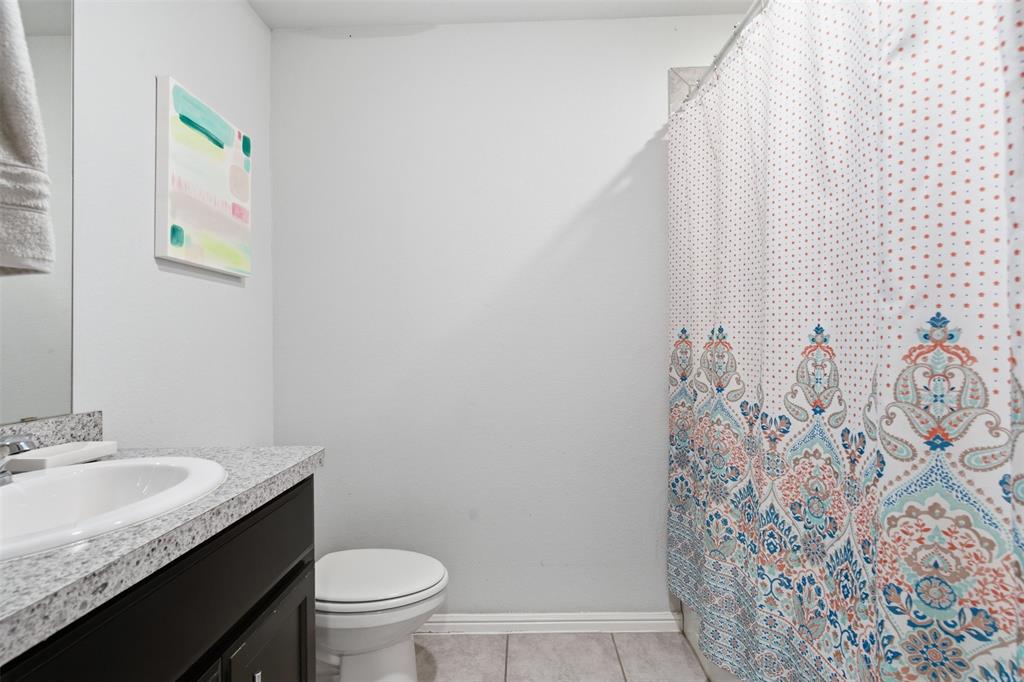 3400 Quiet Valley Road Fort Worth, TX 76123 - Photo 22 of 31 a bathroom with a granite countertop sink and a toilet