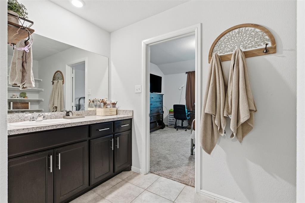 3400 Quiet Valley Road Fort Worth, TX 76123 - Photo 7 of 31 a bathroom with a sink a toilet and a mirror