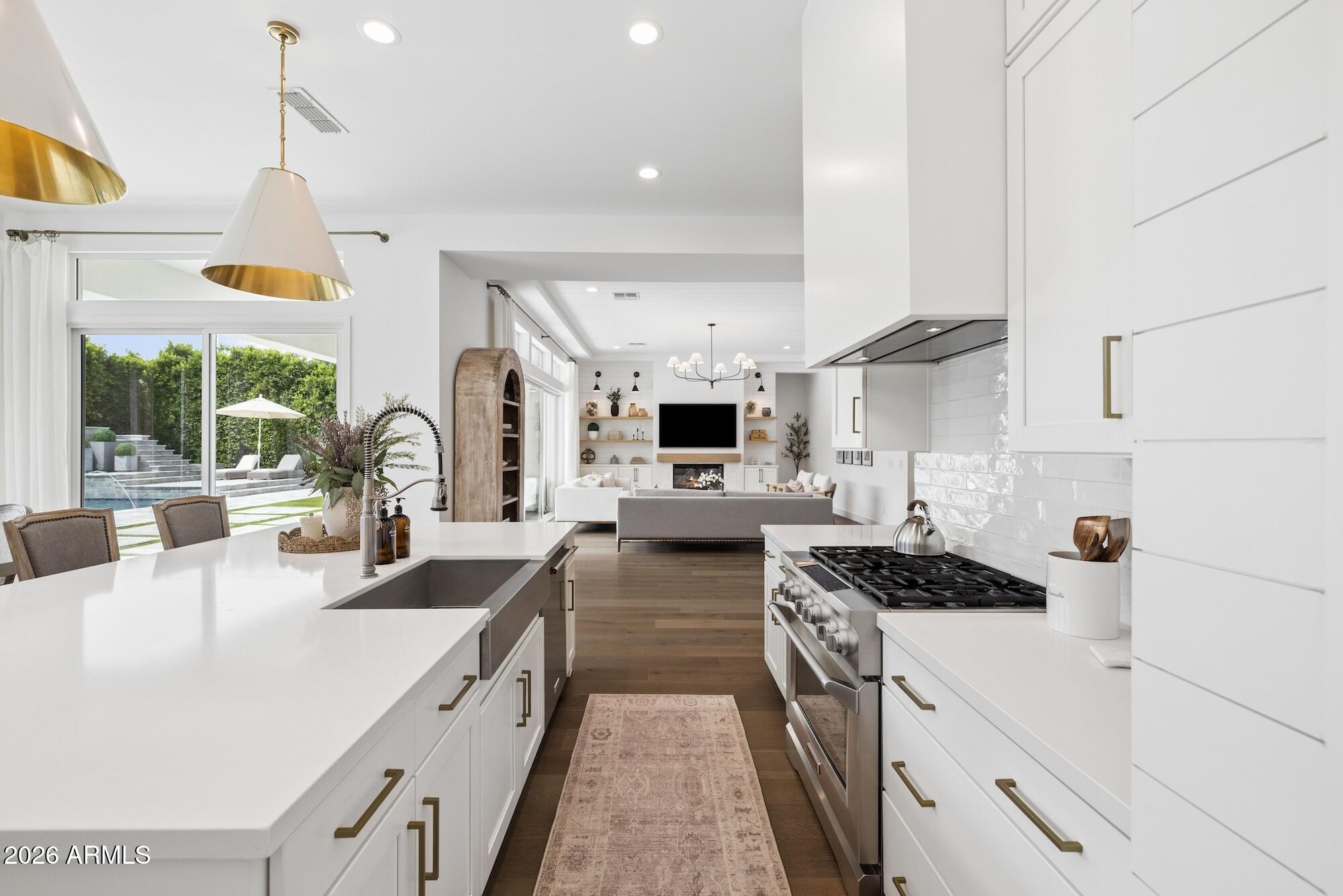 2633 East Geronimo Street Gilbert, AZ 85295 - Photo 21 of 78 a kitchen with stainless steel appliances a sink stove and cabinets