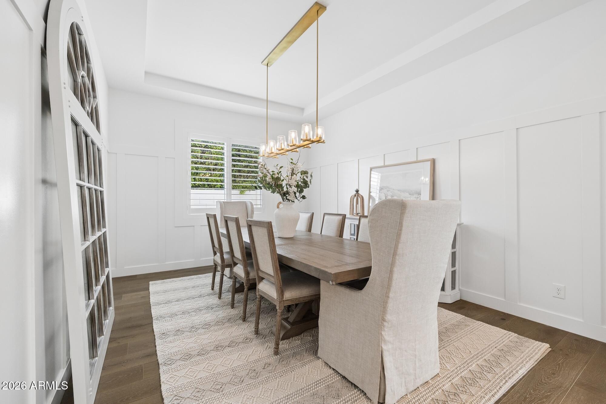 2633 East Geronimo Street Gilbert, AZ 85295 - Photo 25 of 78 a dining room with furniture a chandelier and wooden floor
