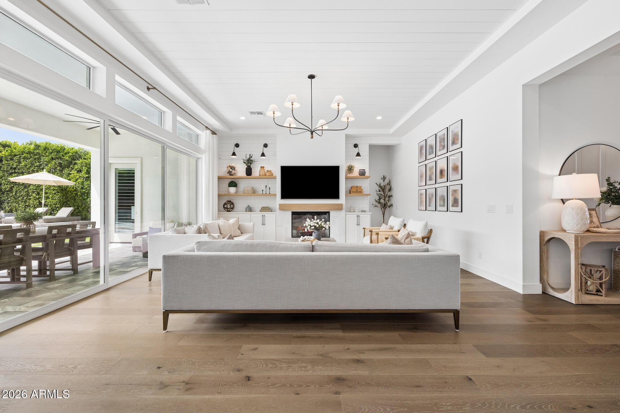 2633 East Geronimo Street Gilbert, AZ 85295 - Photo 9 of 78 a living room with furniture a fireplace and a flat screen tv