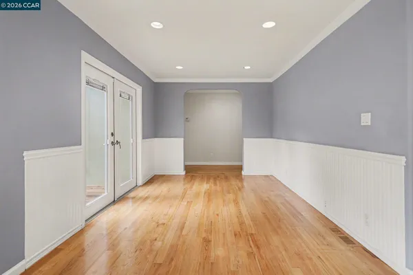 a view of empty room with wooden floor