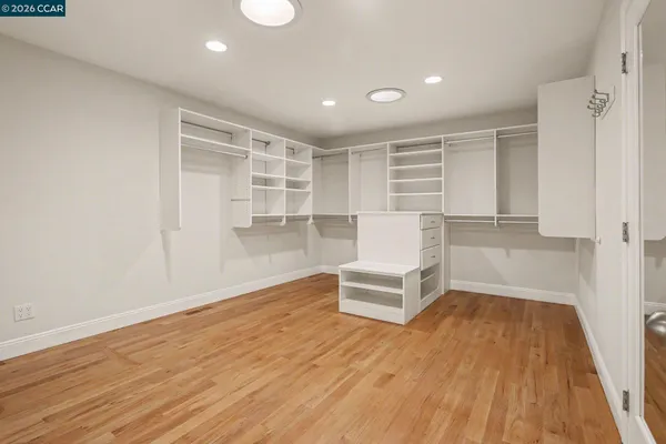 a view of a livingroom with wooden floor and furniture
