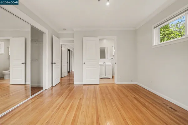 a view of a room with wooden floor and windows