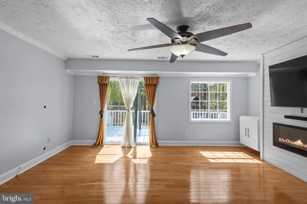 a view of livingroom with hardwood floor and ceiling fan