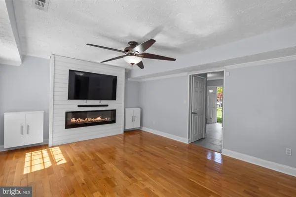 a living room with a flat screen tv and a fireplace
