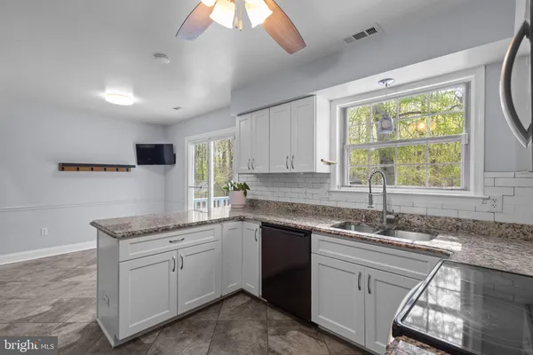 a kitchen with a sink stove and cabinets