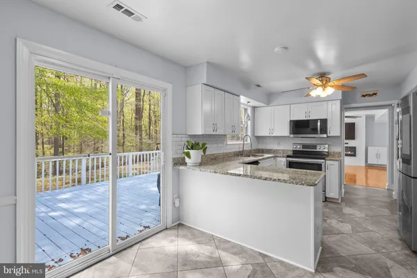 a kitchen with a stove a sink and a refrigerator