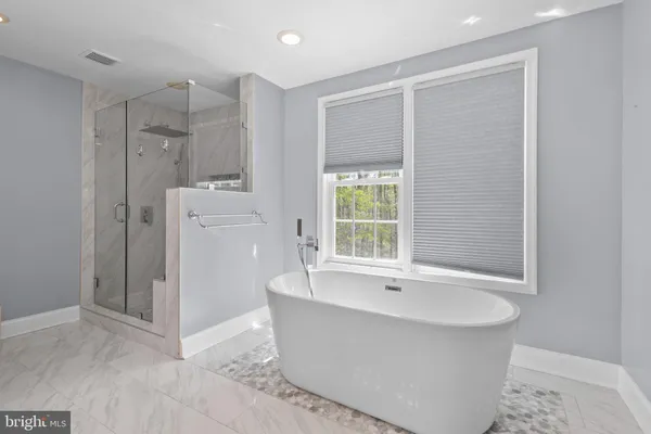 a spacious bathroom with a double vanity sink mirror and toilet