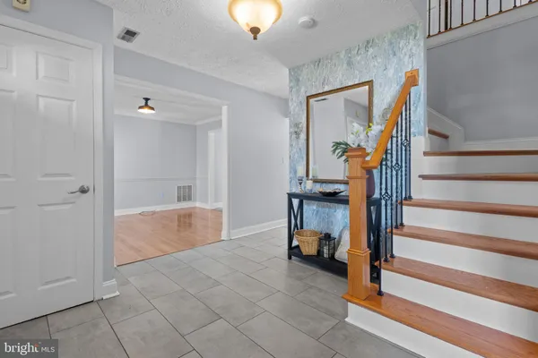 a view of entryway and hall with a workspace