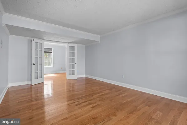 a view of an empty room and wooden floor