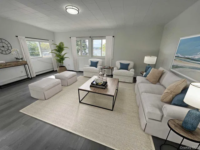 a living room with dining room and wooden floor