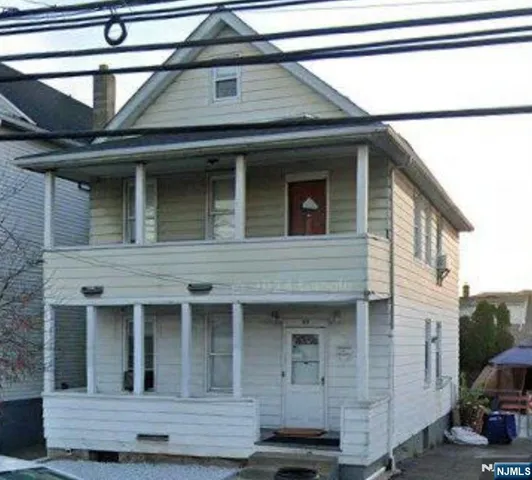a view of a house with a garage and parked car