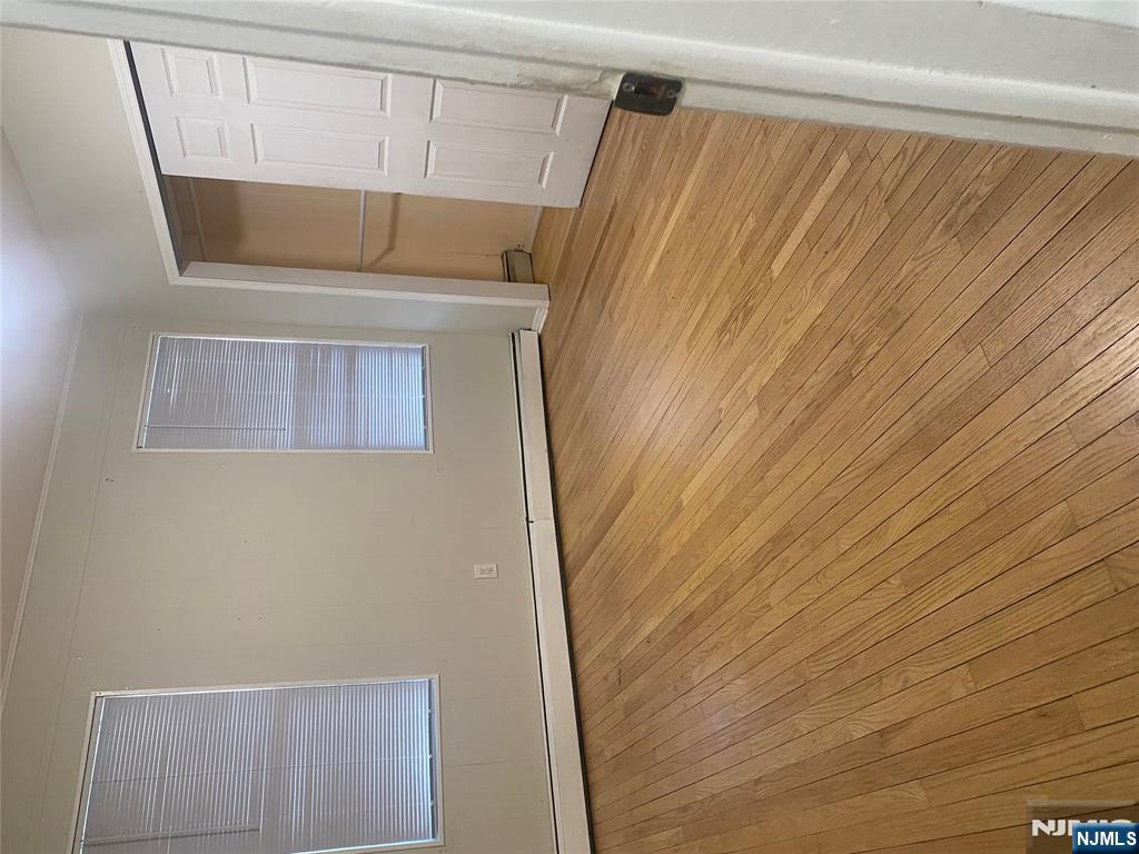 30 Garibaldi Avenue Lodi, NJ 07644 - Photo 7 of 7 a view of an empty room with wooden floor and a window