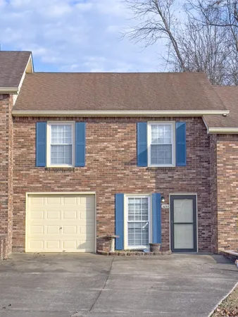front view of a brick house with a street