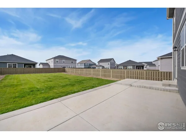 a view of a house with backyard and a garden