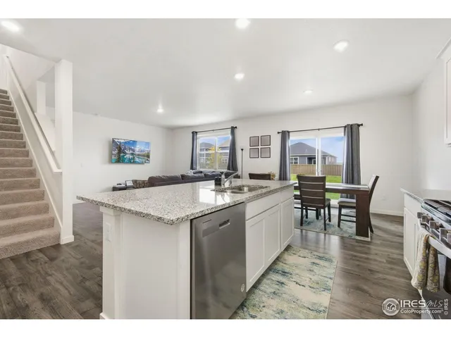 a open kitchen with kitchen island a sink table and chairs