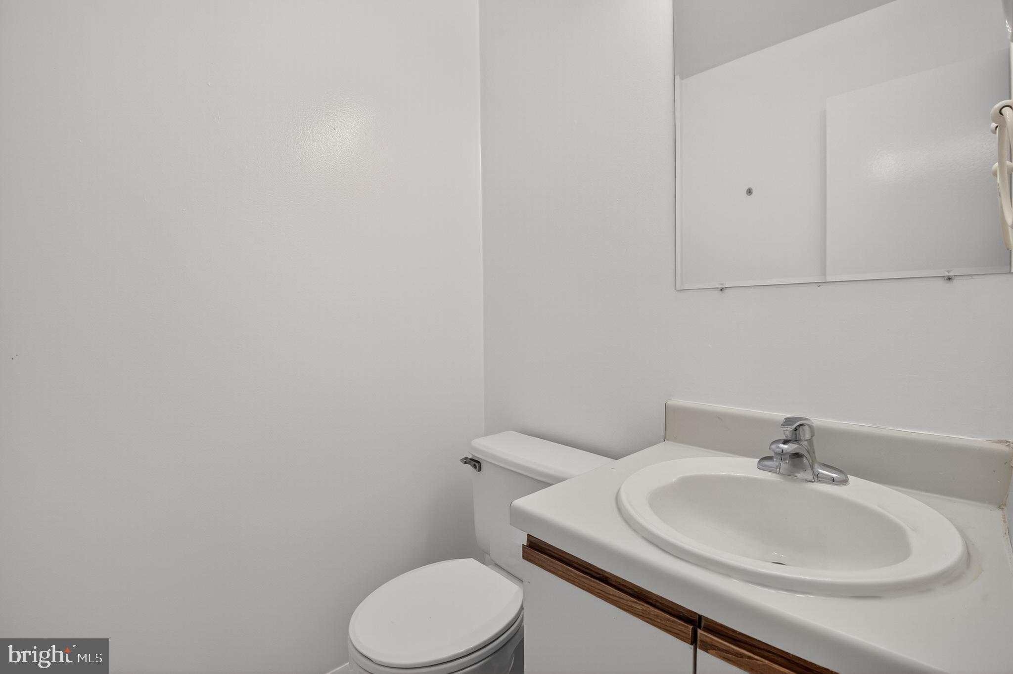 18314 Hallmark Court Gaithersburg, MD 20879 - Photo 12 of 26 a bathroom with a sink toilet and a mirror