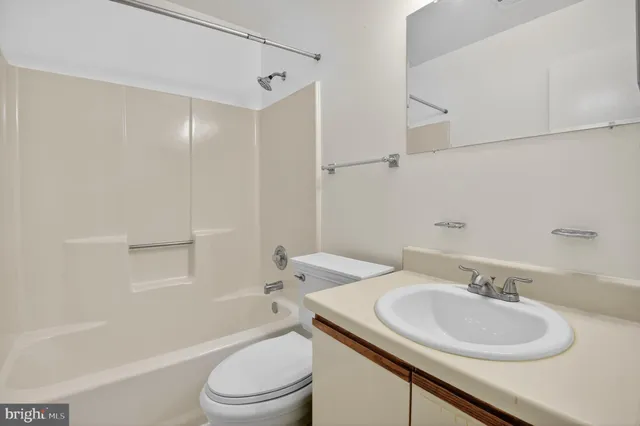 a bathroom with a sink toilet vanity tub and shower